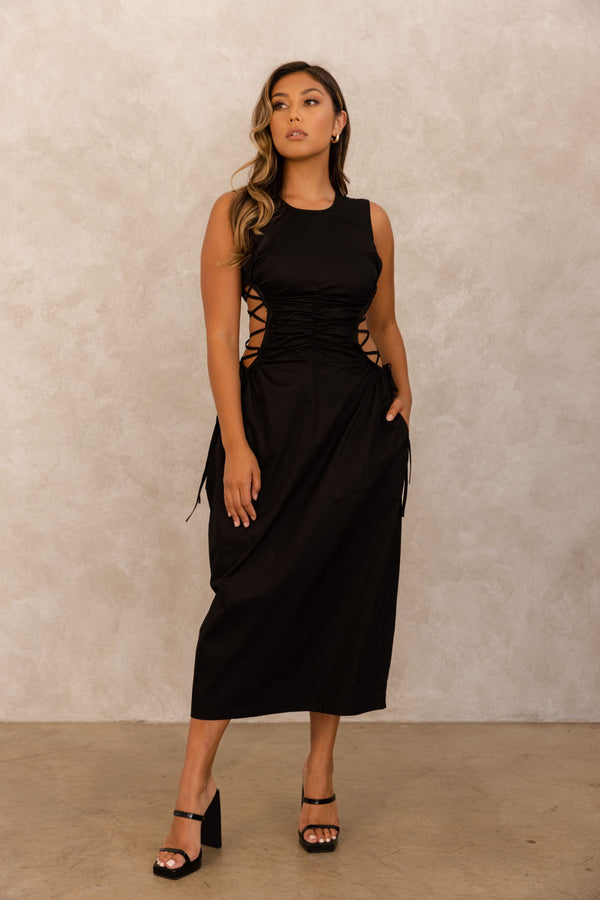A formal black dress is one of a woman's favorites go to pieces. Our Back to Black Dress ﻿is black tie affair ready! This round neck crepe midi dress, is an absolute stunner. This dress looks simple enough but ELILE doesn't do anything simple. This dress is a true conversation started with it's side cutouts with corset ties.