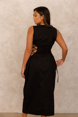 A formal black dress is one of a woman's favorites go to pieces. Our Back to Black Dress ﻿is black tie affair ready! This round neck crepe midi dress, is an absolute stunner. This dress looks simple enough but ELILE doesn't do anything simple. This dress is a true conversation started with it's side cutouts with corset ties.